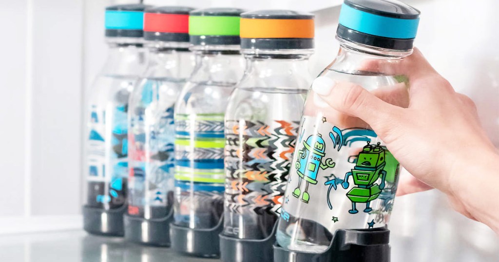 person grabbing a robot print kids water bottle out of fridge from a set of five bottles