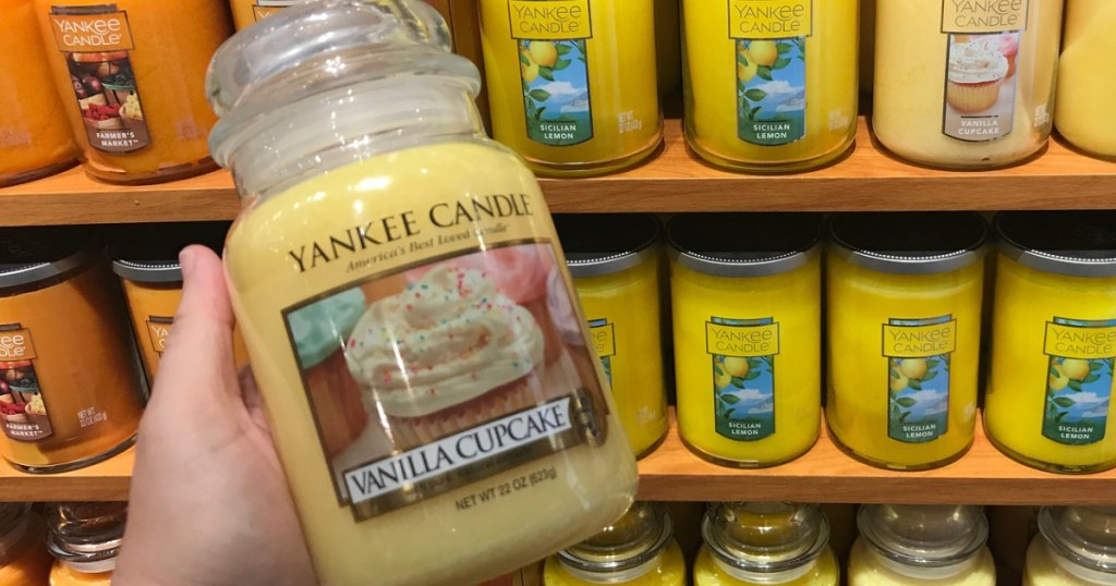 hand holding a large vanilla cupcake Yankee Candle