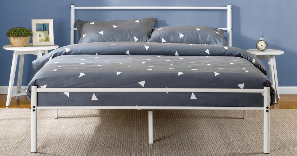white bed frame and headboard with mattress with blue and white bedding
