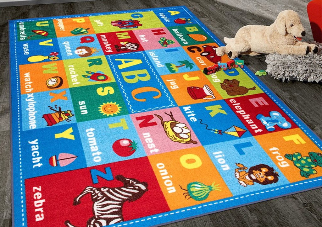 colorful kids alphabet area rug on hardwood floor with plush stuffed dog
