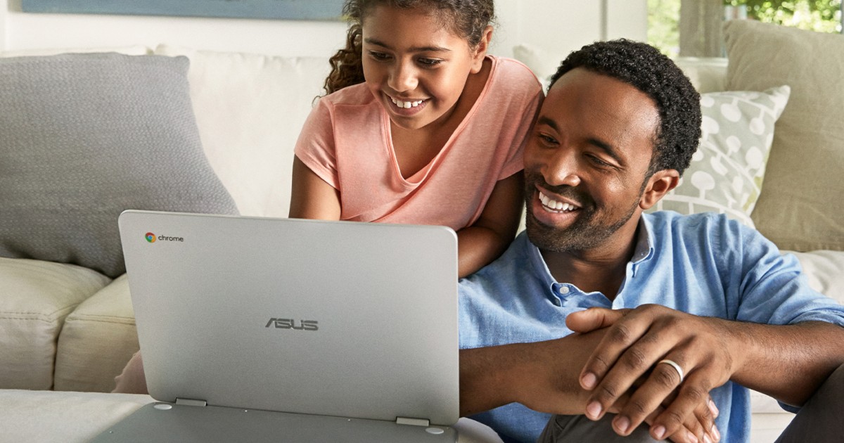 man and child looking at laptop