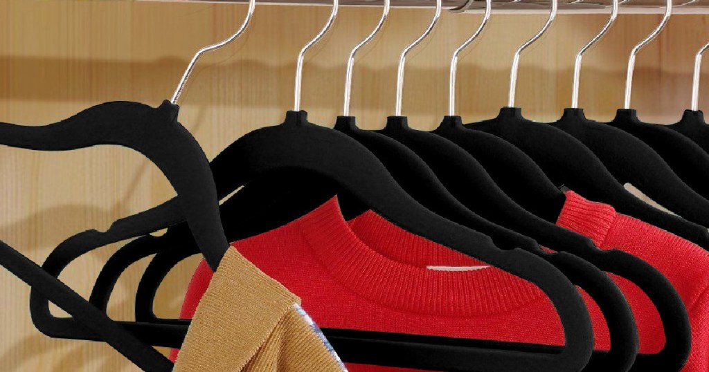 black felt hangers holding sweaters