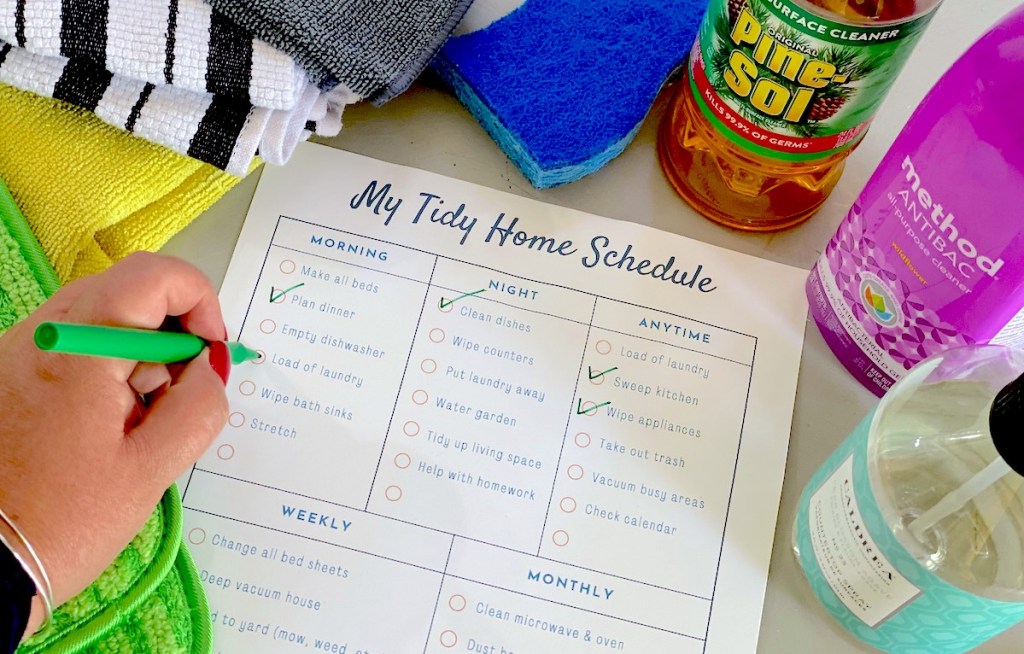 hand checking off printable chore chart