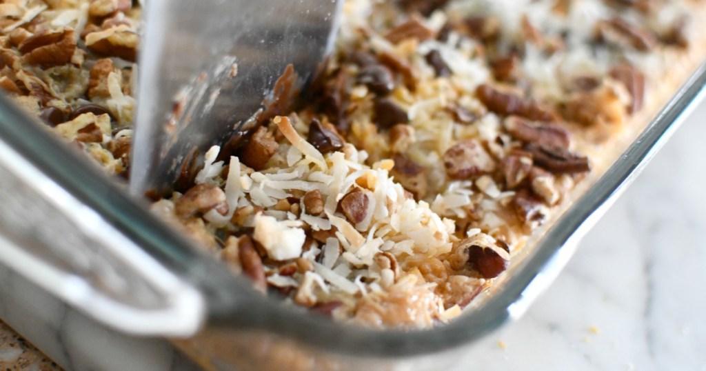 cutting into magic cookie bars