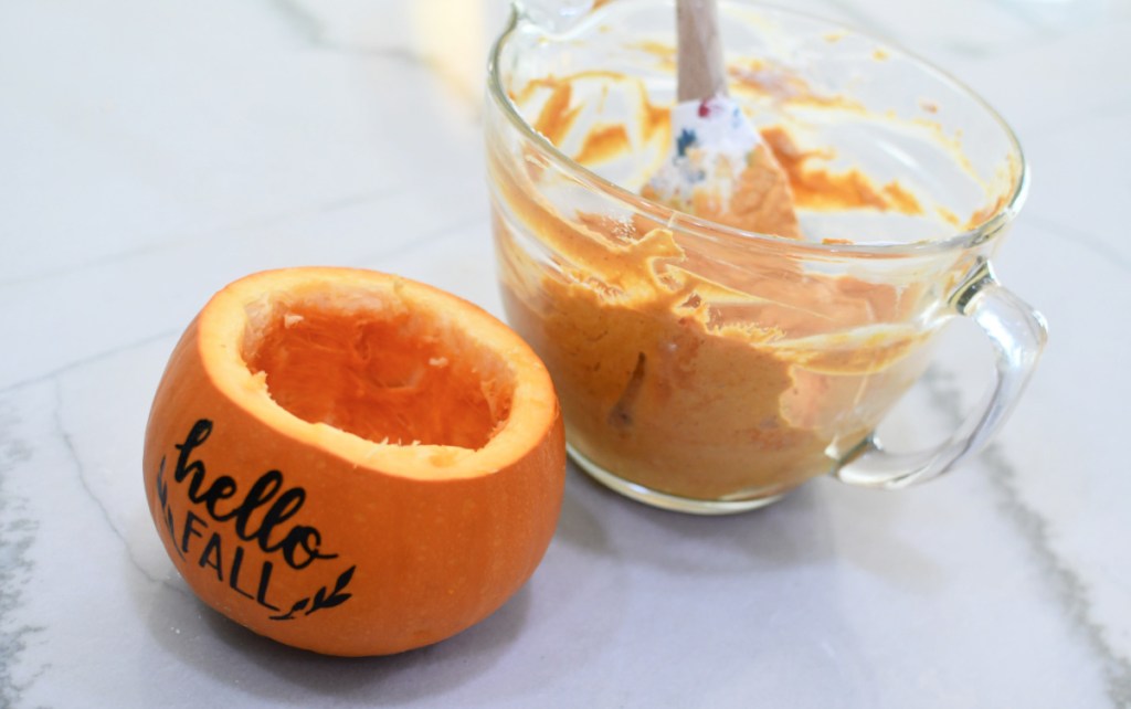 emptying out a fresh pumpkin to use for dip holder