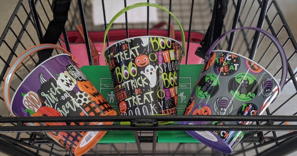 shopping basket with three small buckets with Halloween decorations on them