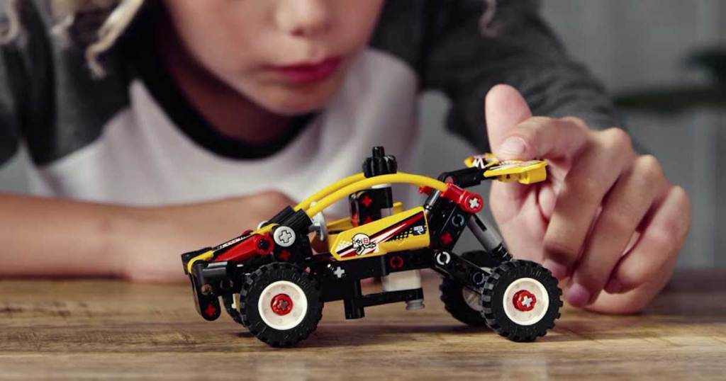 boy playing with lego dune buggy