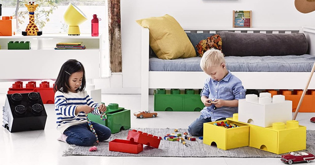 2 kids playing in living room with LEGOS