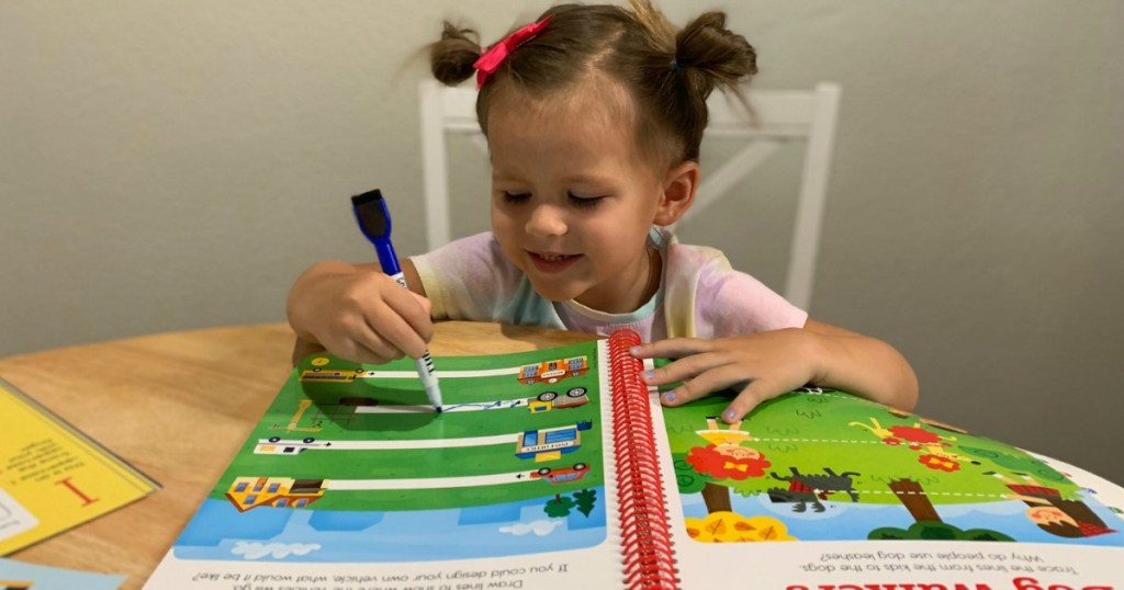 girl writing in a highlights book