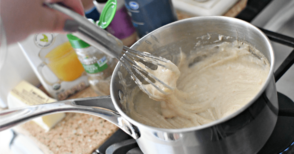 whisking cream of chicken soup in pot