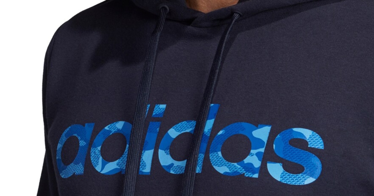 Men's adidas pullover hoodie in blue a close up of the upper logo portion of the sweatshirt in blue