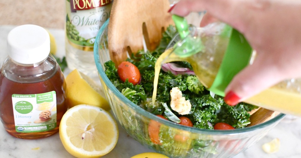 pouring dressing into a salad bowl