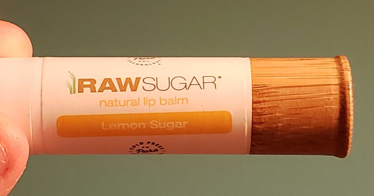 hand holding Raw Sugar lip balm