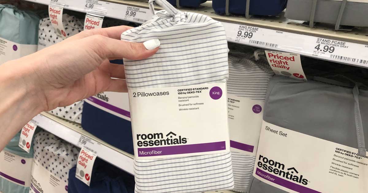 hand holding a set of room essentials sheet sets