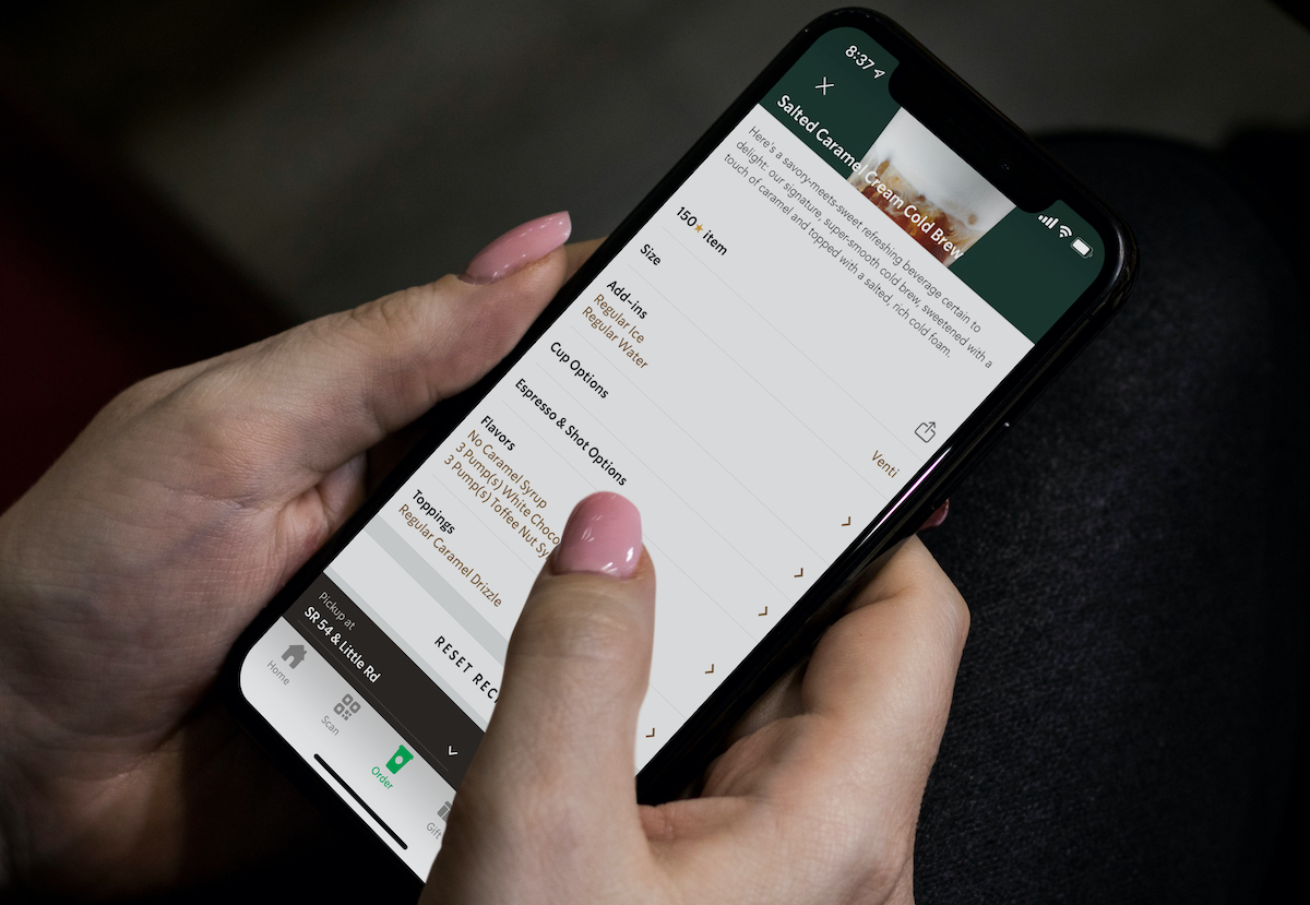 hands holding phone ordering starbucks secret menu salted caramel drink on mobile