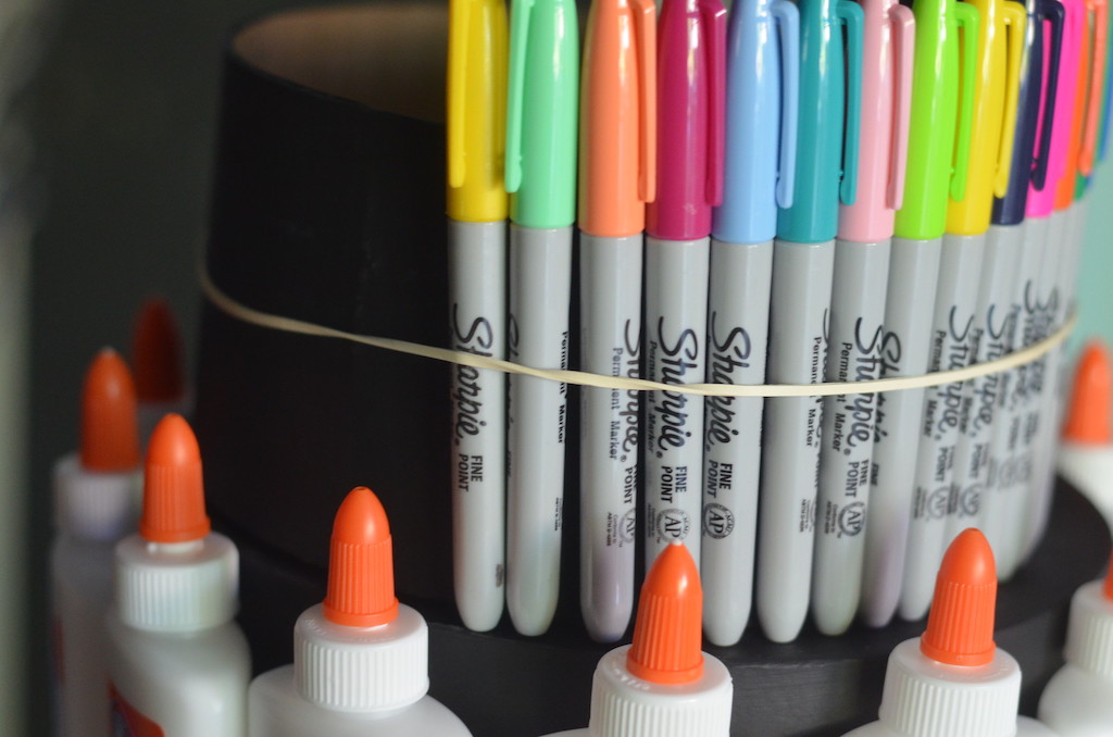 Sharpie markers attached to box with rubber bands 