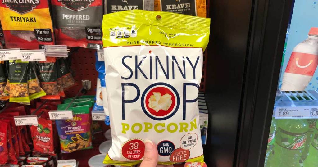 hand holding bag of skinny pop popcorn