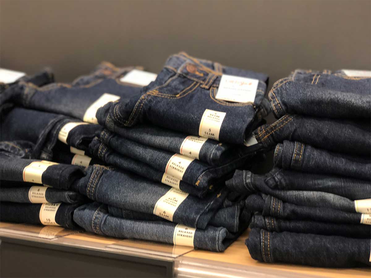 kids jeans stacked up on display in store