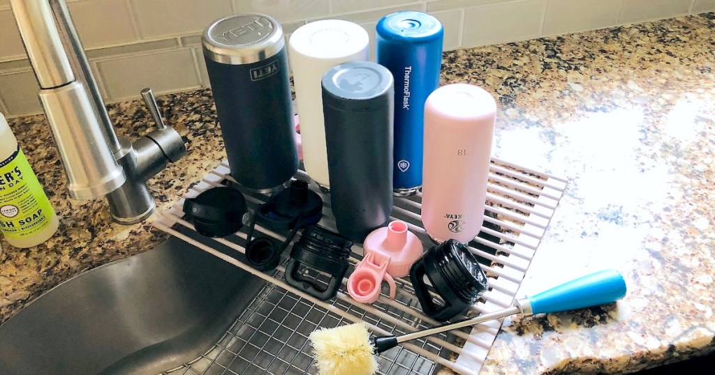 how to clean water bottles various colors and styles of reusable water bottles on drying rack 