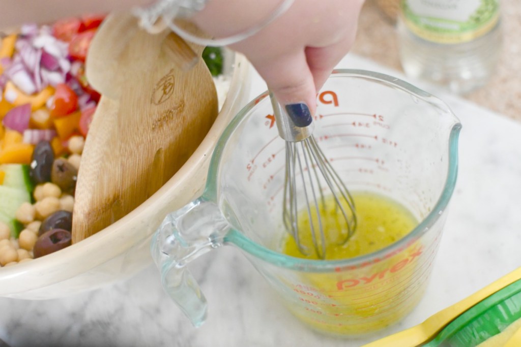 whisking up greek salad dressing