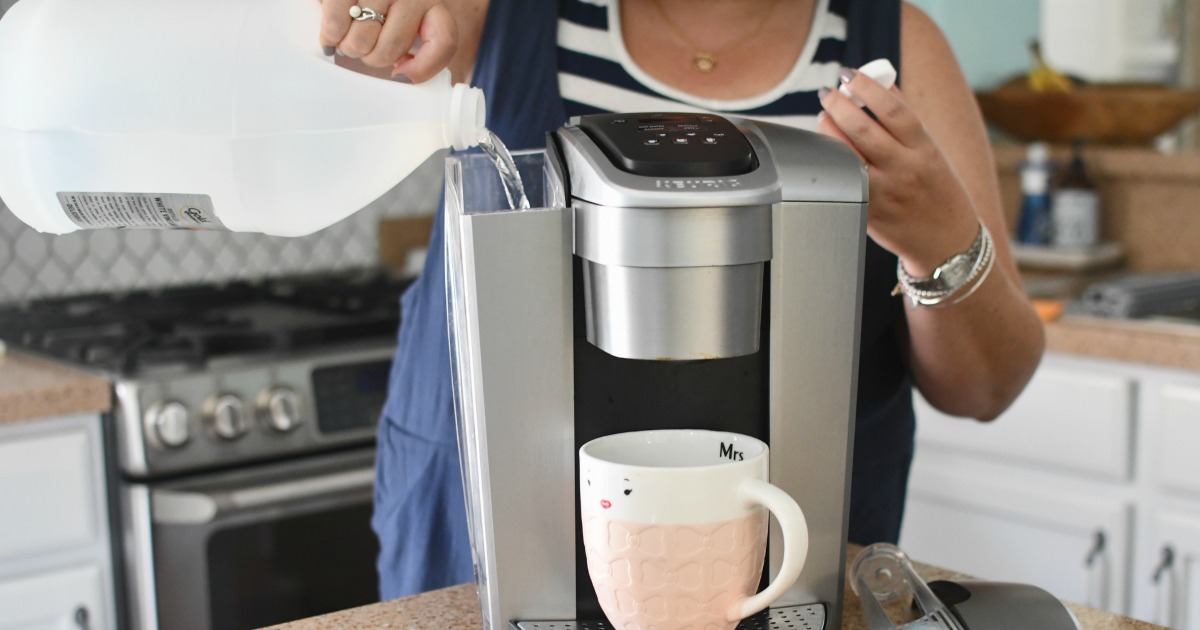 woman pouring vinegar into coffee maker