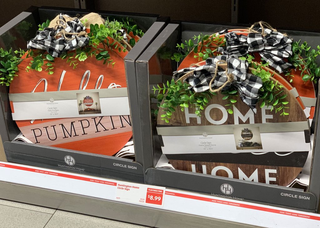 circular fall themed decor signs with burlap bows on ALDI store shelf