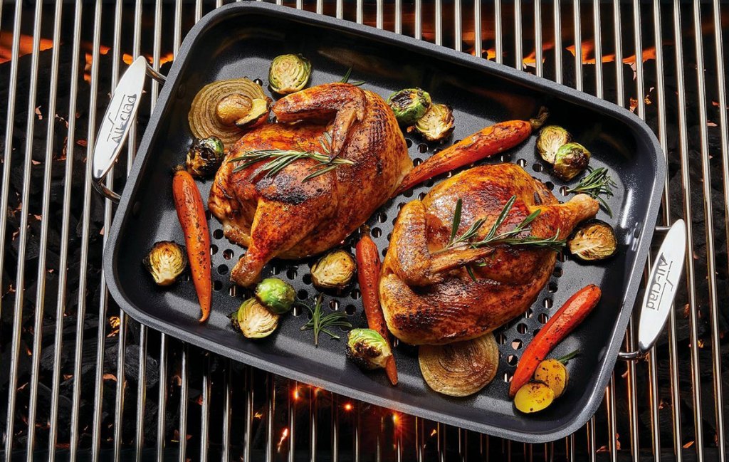 rectangular non-stick roasting pan on grill with roasted chicken and vegetables