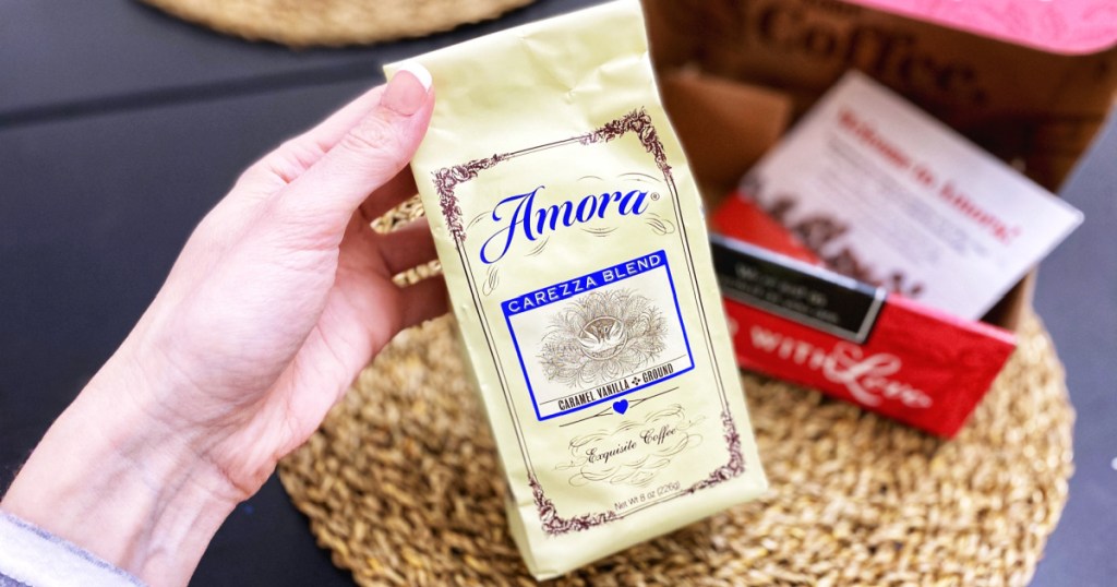 hand holding Amora Caramel Vanilla Coffee
