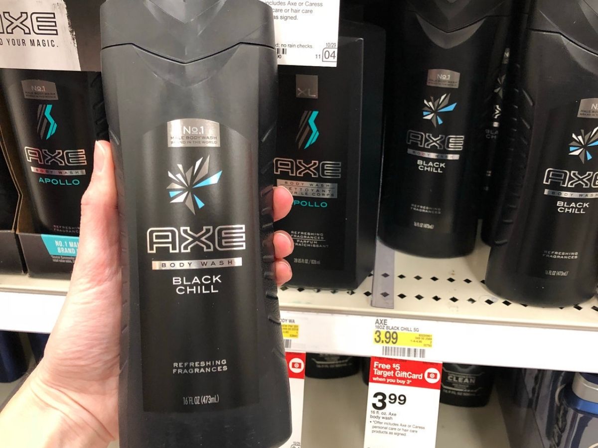 Woman's hand holding up bottle of Axe Body Wash