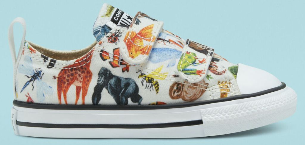 white converse with multiple zoo animals drawn on them with light blue background