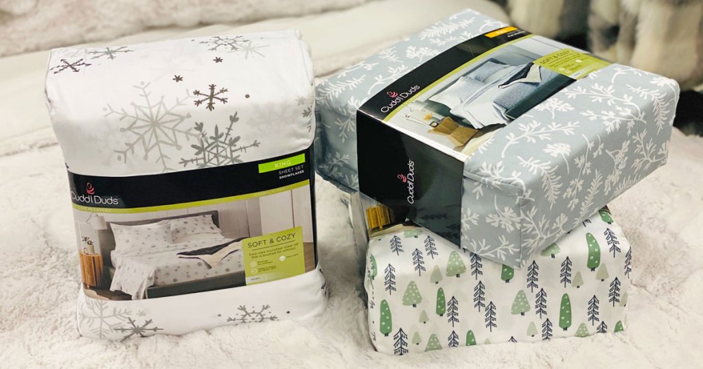 three sets of christmas printed flannel set sets on a white bed