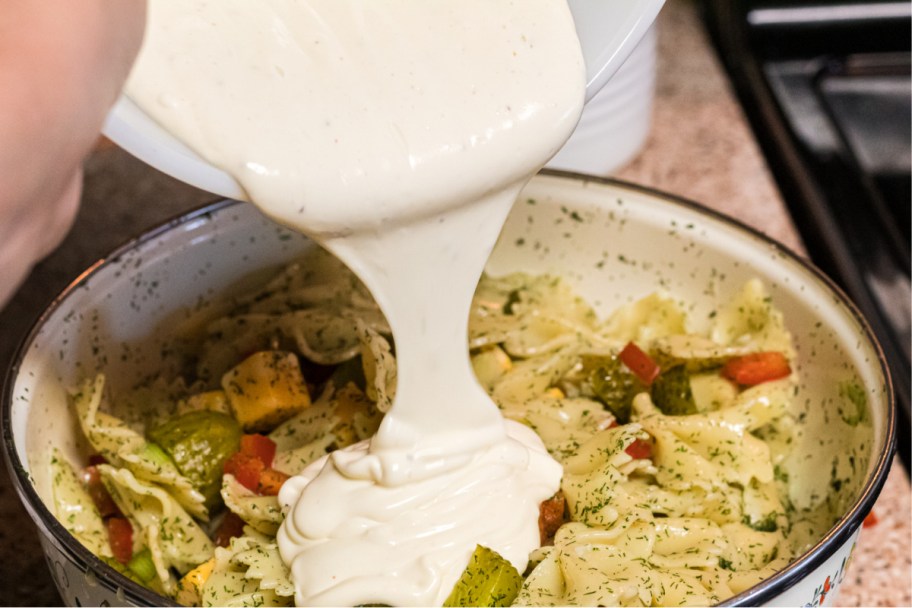 pouring dressing in salad