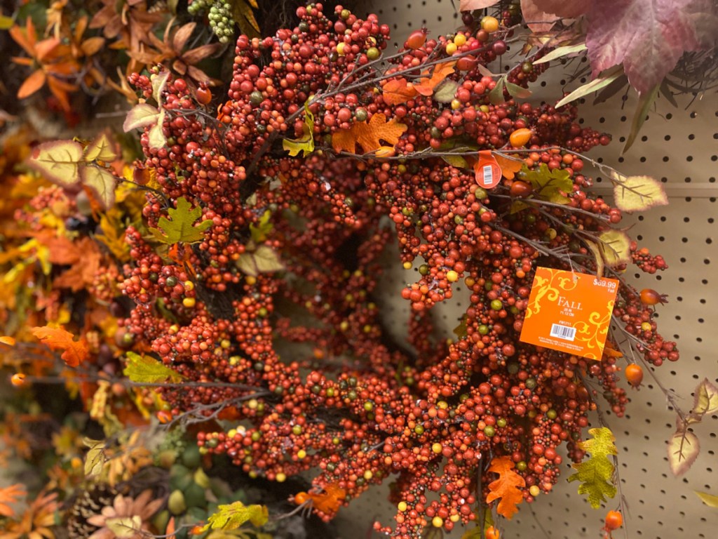 fall berry wreath hanging in store
