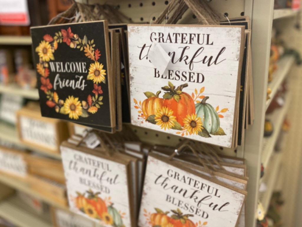 Fall themed wood wall decor hanging in store