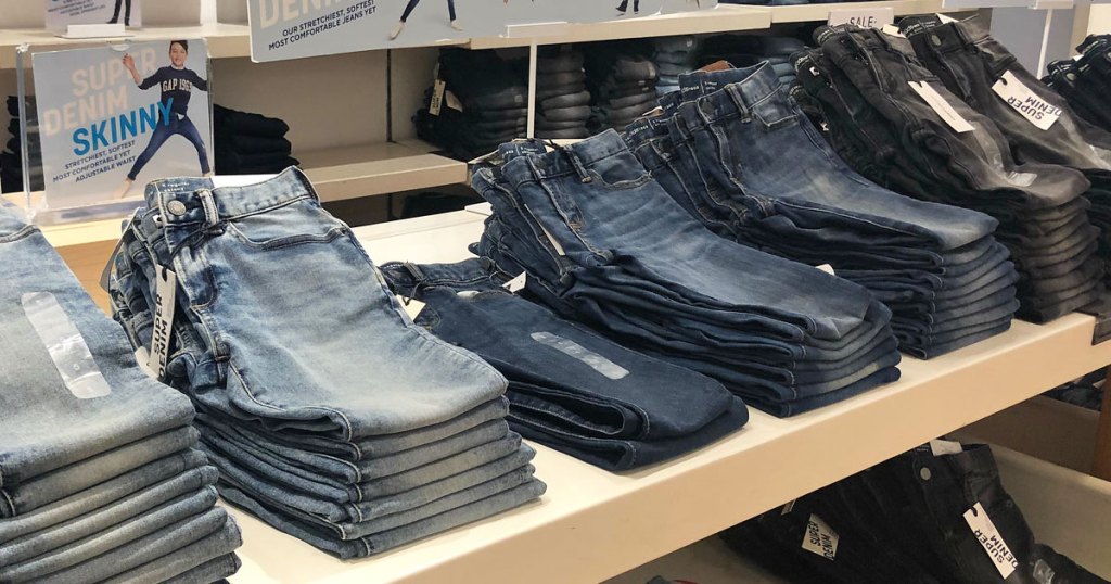 store display table full of different washes of kids jeans