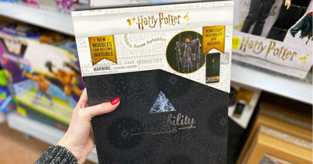 woman holding up a Harry Potter invisibility cloak