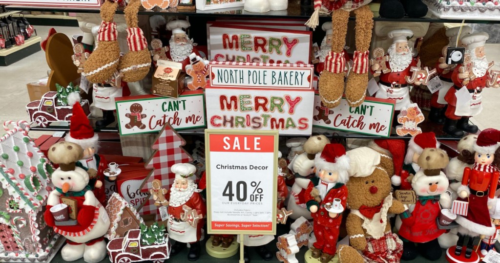 various Christmas decor and items with sale sign on store display table