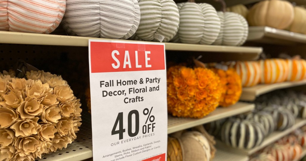 various pumpkin decor and sale sign on store shelves