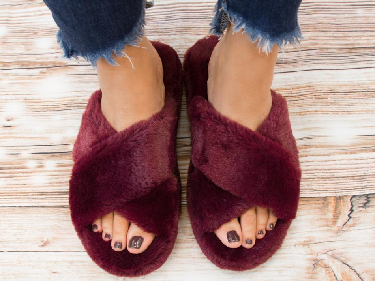 legs wearing burgundy open-toed slippers 