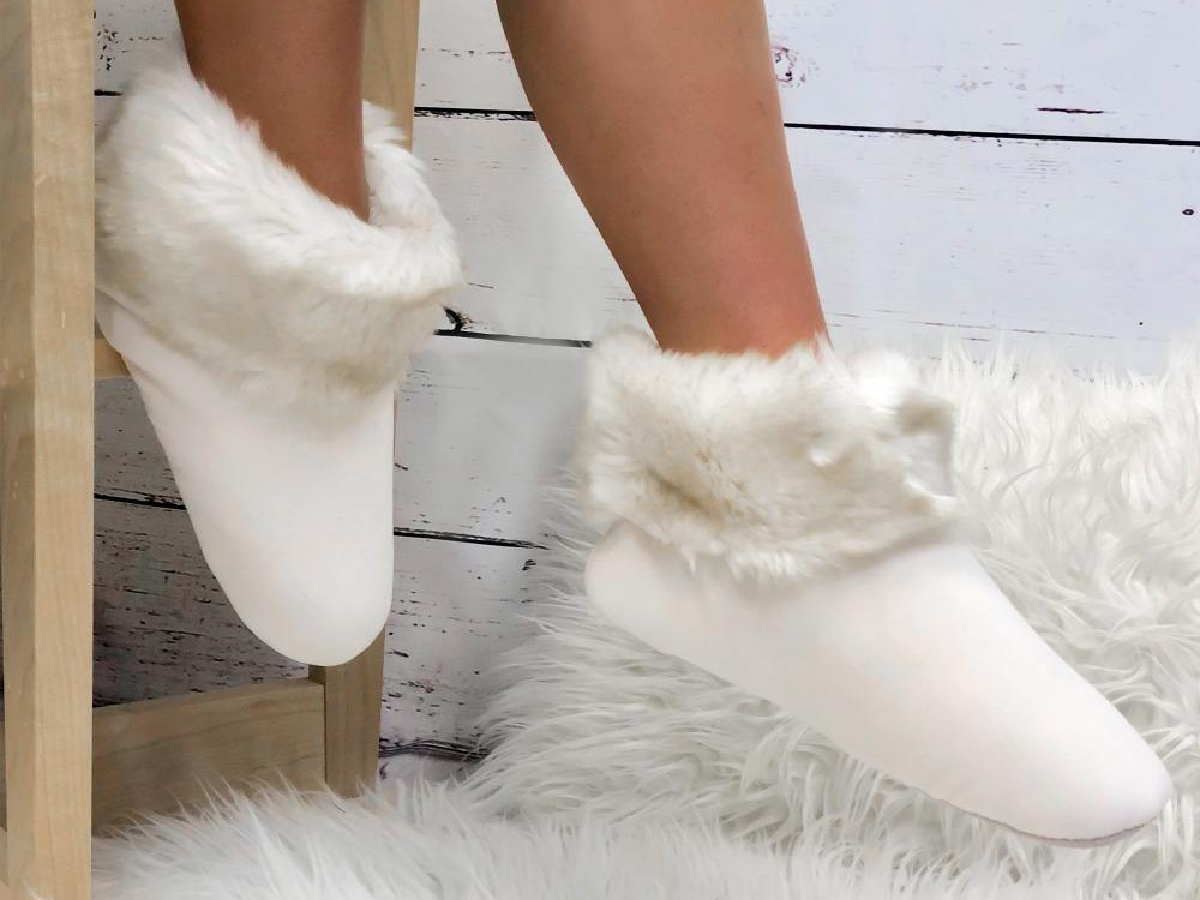 legs wearing white fluffy slippers