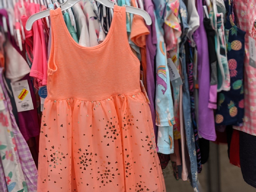 toddler girls coral tulle dress hanging in store