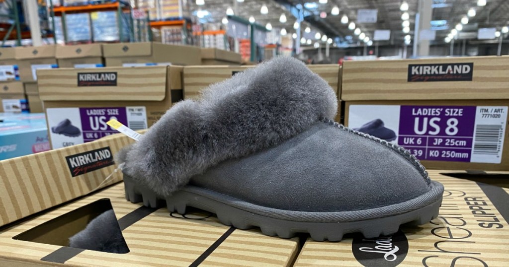 Kirkland shearling slipper on top of shoeboxes at Costco