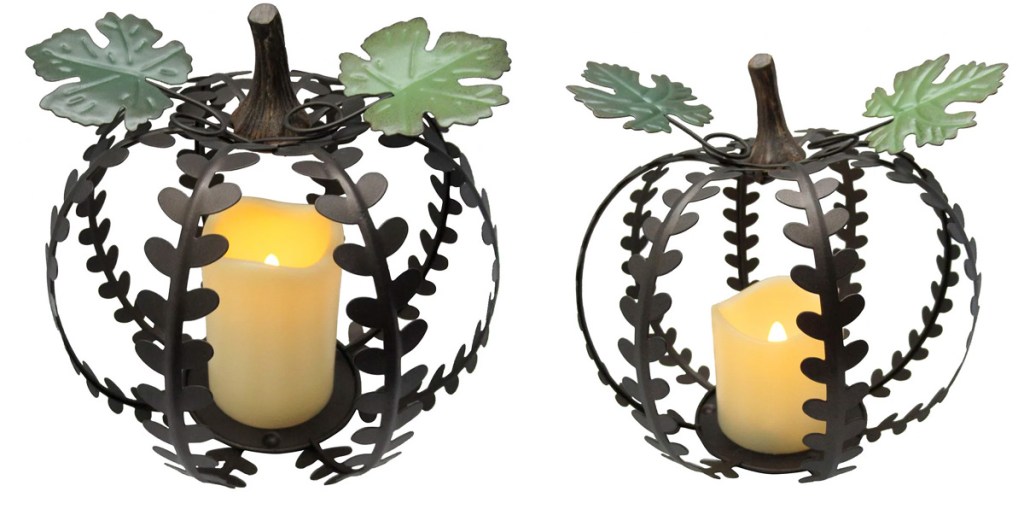 two metal pumpkin shaped decor pieces with led pillar candles inside