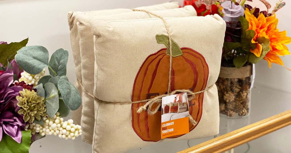 pumpkin throw pillow 3-pack on kohl's shelf near fall flowers
