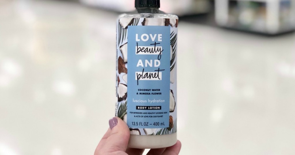 hand holding up Love Beauty Planet lotion