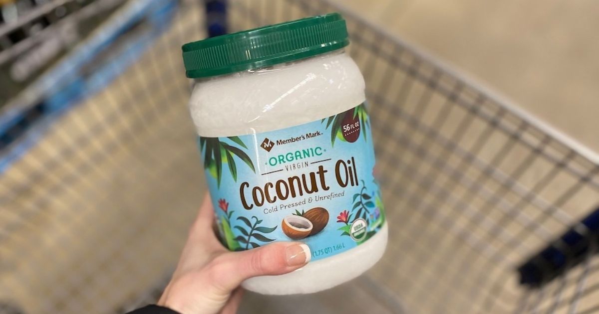 hand holding a jar of coconut oil