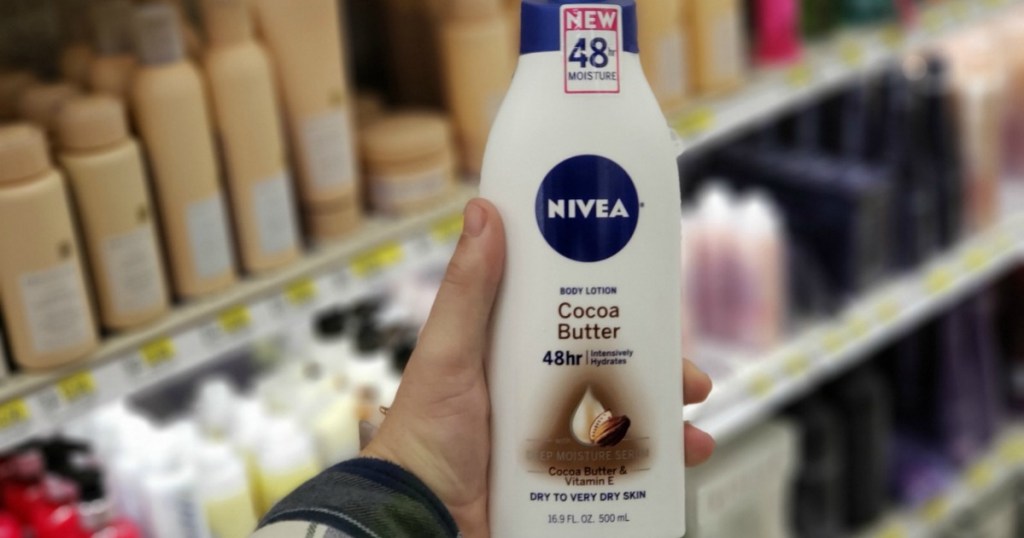 Man's hand holding Nivea Cocoa Butter Lotion