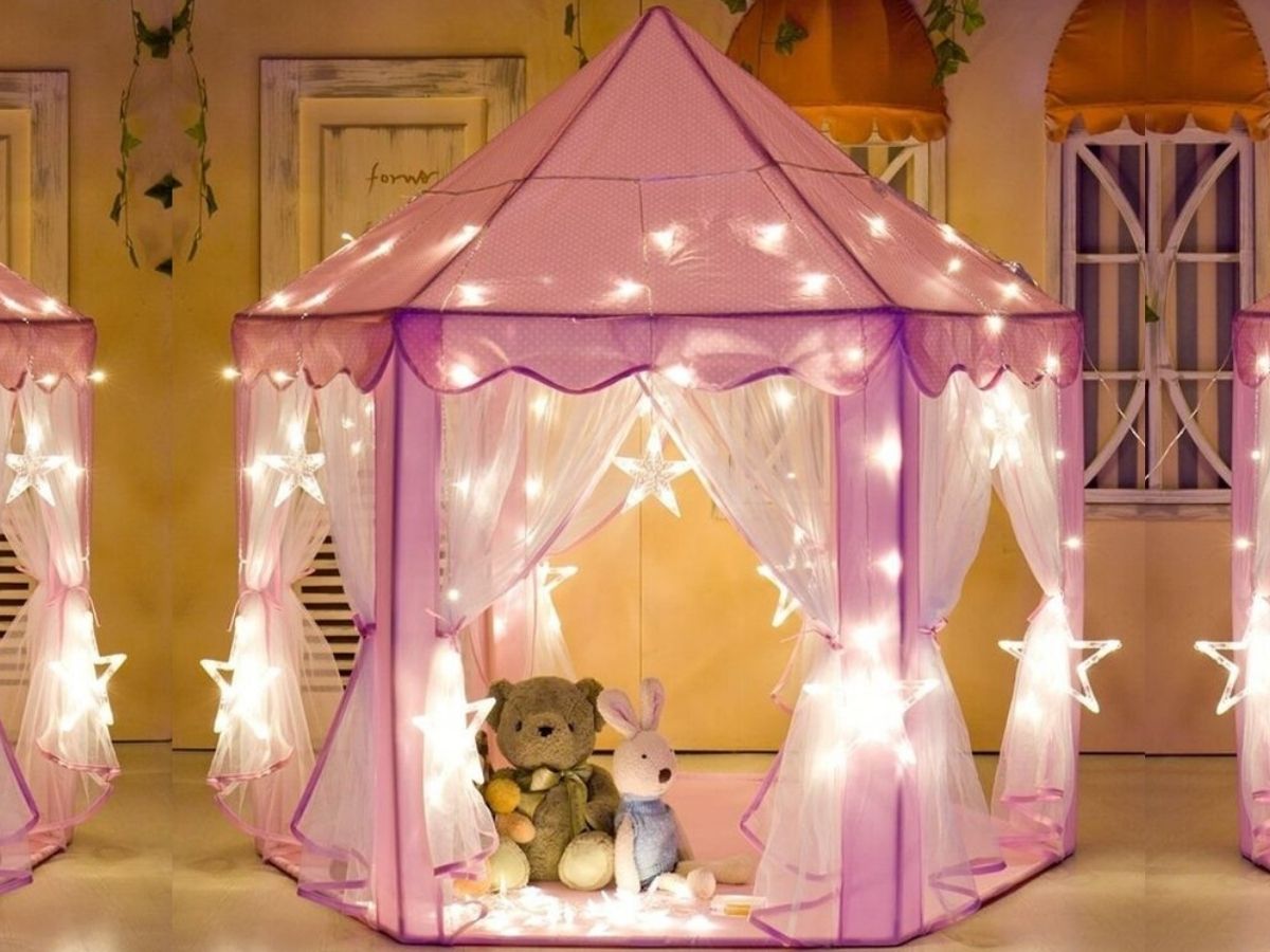 pink tent with lights and stuffed animals inside