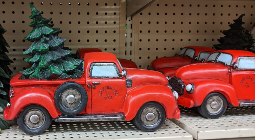 red truck with Christmas tree in bed decor on store shelf