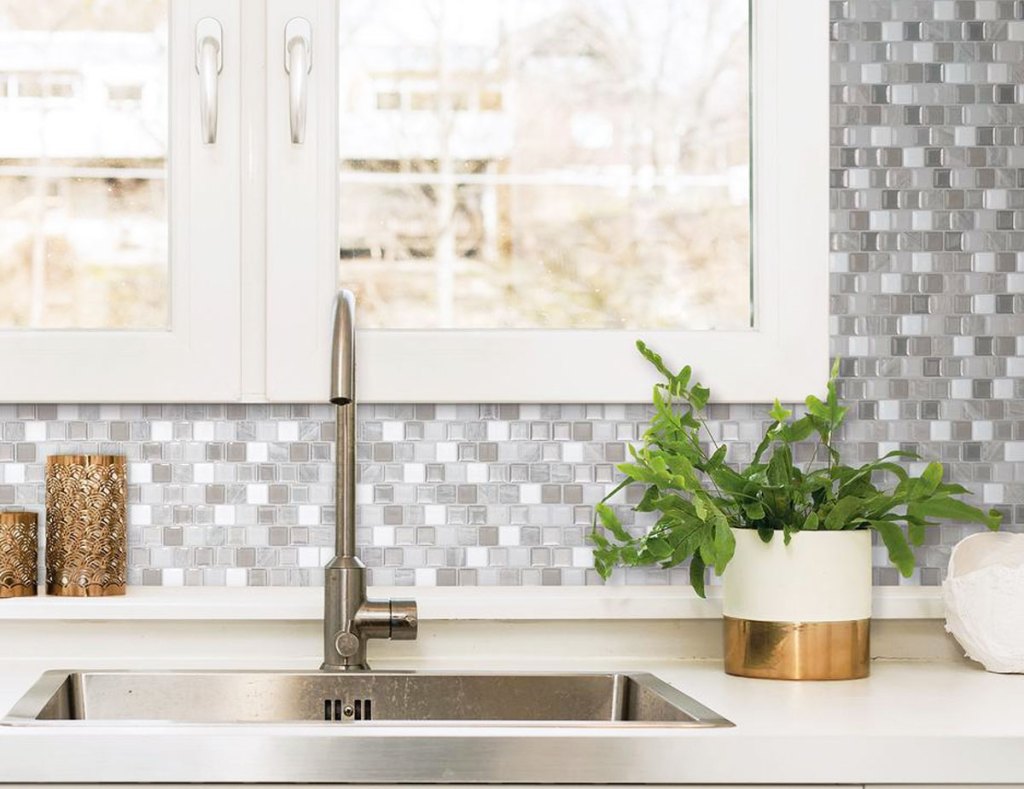 grey and white peel and stick mosaic backsplash on wall behind kitchen sink